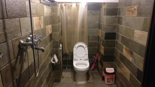 a small bathroom with a toilet in a stall at Temple House in Kathmandu