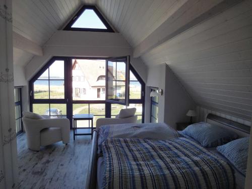a bedroom with a bed and a large window at Ferienhaus Seeraeuber in Vieregge