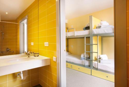 a bathroom with a sink and a mirror at Twentytu Hostel Barcelona in Barcelona