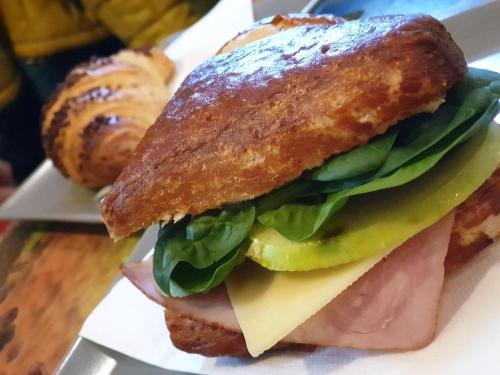 a sandwich with ham lettuce and cheese on a plate at CENTER rooms in Miskolc