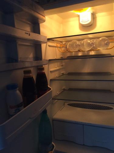 an open refrigerator with bottles of food and drinks at Appartamento a Viterbo in Viterbo