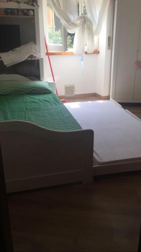 a bed in a room with a window and a bed frame at Appartamento a Viterbo in Viterbo