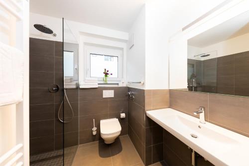 a bathroom with a toilet and a sink and a shower at Boardinghouse St.Pauli in Hamburg