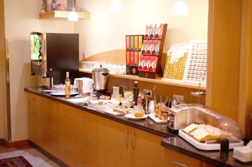 a kitchen with a counter with food on it at Hotel Feichtinger Graz in Graz