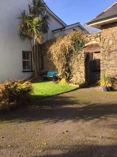 a house with a palm tree next to a building at Redington House SelfCatering accommodation in Cobh