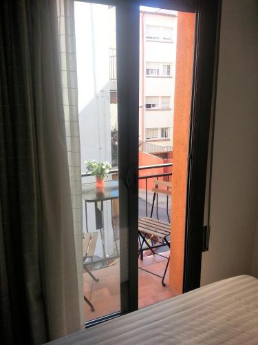 a bedroom door with a view of a balcony at Hostal La Lluna in Arenys de Mar