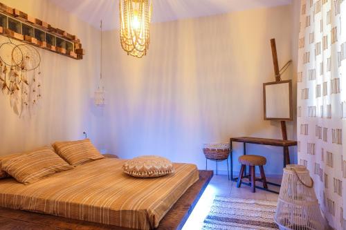 a bedroom with a bed and a table and a stool at Relux Apartment in Agios Nikolaos