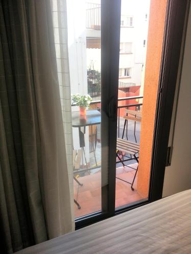 a sliding glass door with a view of a balcony at Hostal La Lluna in Arenys de Mar