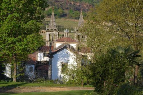 an old building with turrets on a hill with trees at Quinta do Mosteiro in Felgueiras