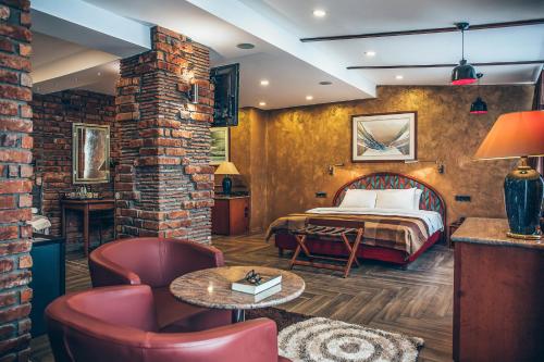 a hotel room with a bed and a brick wall at Hotel Super 8 in Skopje