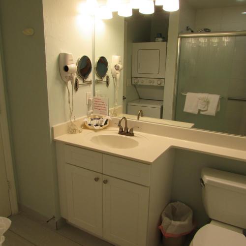 a bathroom with a sink and a mirror at Edison Beach House in Fort Myers Beach