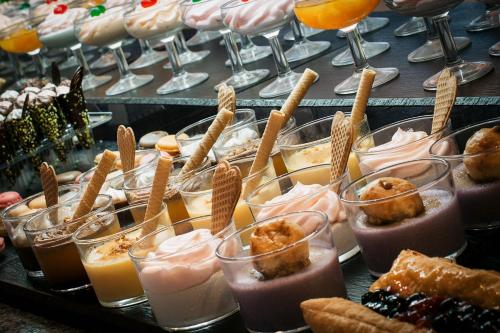 a bunch of desserts in glasses on a table at Bellevue Vistanova in Magaluf