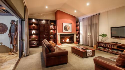 a living room with a couch and a fireplace at Manor 38 in Port Elizabeth