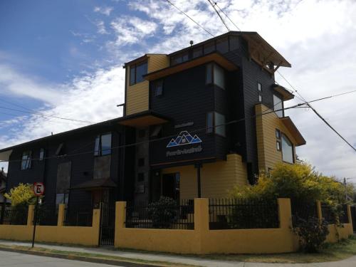 a black and yellow building on the side of a street at Puerto Austral in Puerto Varas