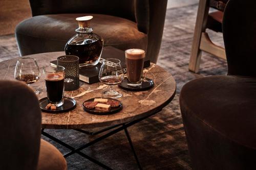 a table with two glasses and a bottle of alcohol at Comwell Kongebrogaarden in Middelfart
