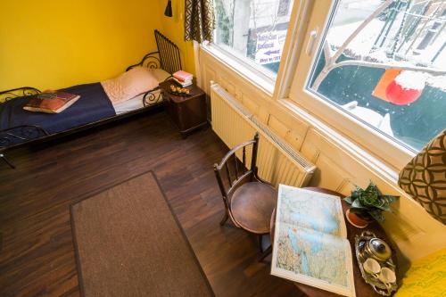 a small room with a bed and a window at Baroque Hostel & Coworking in Budapest