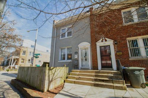 a brick house with a staircase in front of it at The Gray Corner House by Gallaudet 3 BR 2 BA in Washington