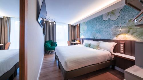 a hotel room with a large bed in a room at voco Strasbourg Centre - The Garden by IHG in Strasbourg