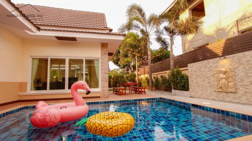 a swimming pool with a pink flamingo in a house at Hansa Paradise Hill Pool Villa in Nong Prue