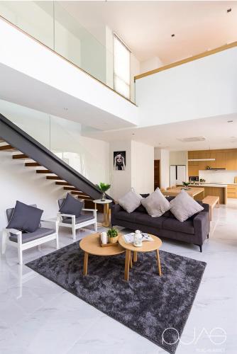 a living room with a couch and a table at Vmoon villa chiangmai in Chiang Mai