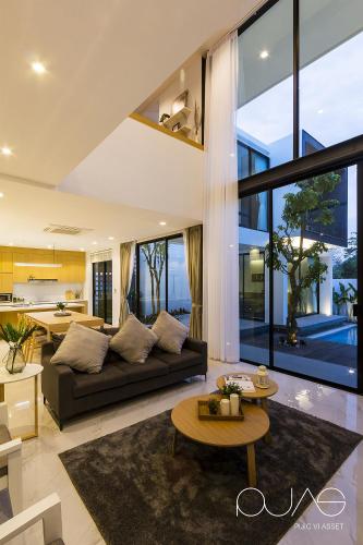 a living room with a couch and a table at Vmoon villa chiangmai in Chiang Mai