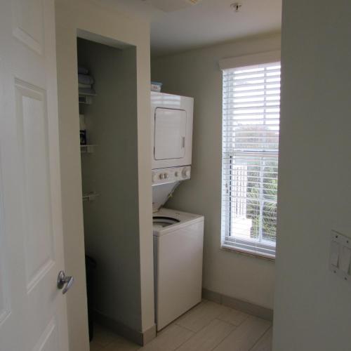 a laundry room with a washer and dryer and a window at Edison Beach House in Fort Myers Beach