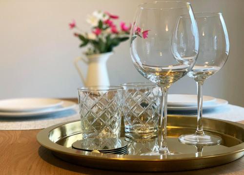 a tray with wine glasses on a table at Strand House 2 in Portstewart
