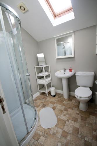 a bathroom with a toilet and a sink at Portstewart Coastal 3 Bedroom House with Free Parking in Portstewart