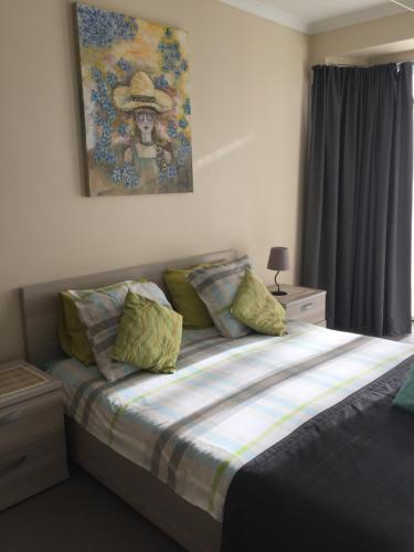 a bedroom with a bed with a woman wearing a hat at Residentie Royal Park in Ostend