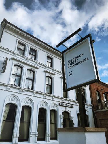 a sign in front of a white building at Frederick Street Townhouse in Birmingham