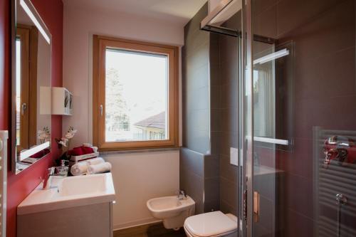 a bathroom with a toilet and a sink and a shower at B&B LeTerrazze Boutique Hotel - Torino in Ciriè