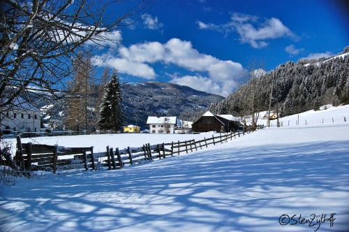 a snow covered field with a fence and a house at Schloss Berg Klösterle in Zedlitzdorf
