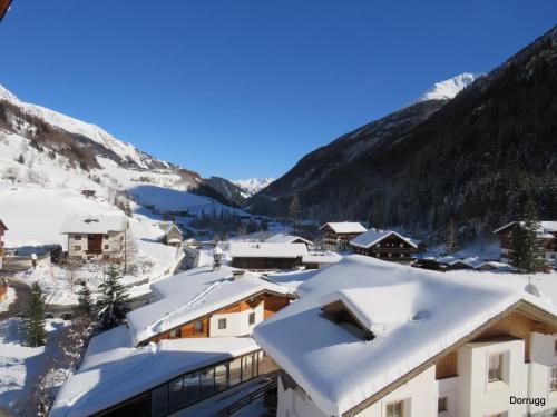 a village covered in snow with mountains in the background at Gästehaus Dorer Gerhard in Prägraten am Großvenediger