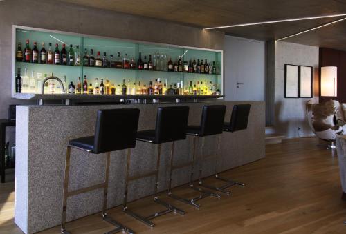 a bar with black stools in a room at Casa de Uco Vineyards and Wine Resort in Los Árboles