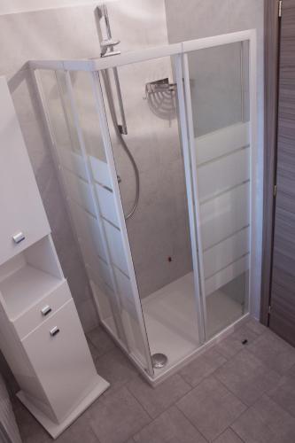 a shower with a glass door in a bathroom at La Poesia del Lago in Oggiono