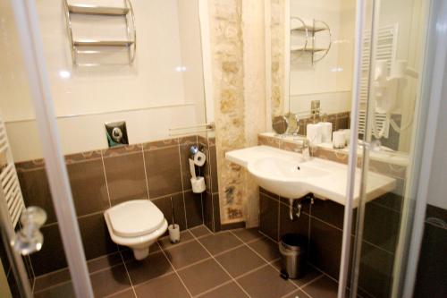 a bathroom with a toilet and a sink at Palace Augubio in Split