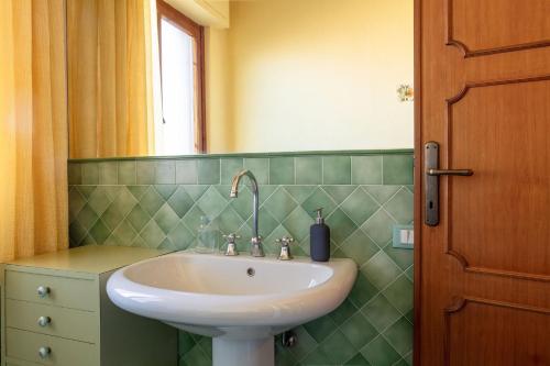 a bathroom with a sink and a mirror at Appartamento Tina in Lido di Camaiore