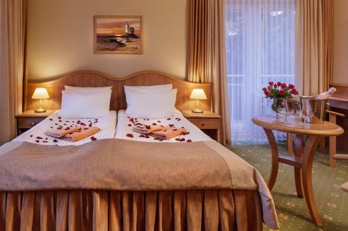 a bedroom with a bed with two pillows on it at Hotel Polaris III in Świnoujście