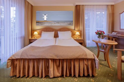 En eller flere senge i et værelse på Hotel Polaris III