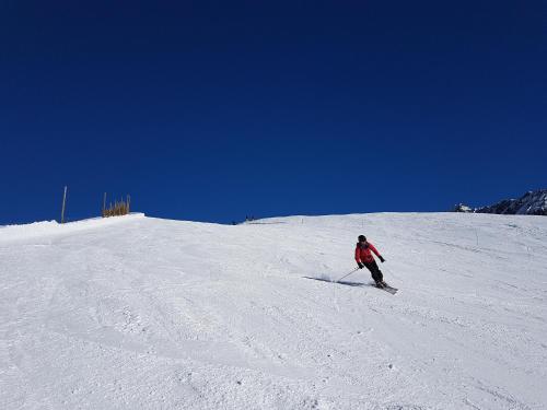 a person is skiing down a snow covered slope at Chalet Solneige in Vaujany