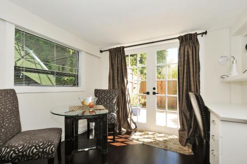 a living room with a table and chairs and a window at The Craigmyle Inn in Victoria