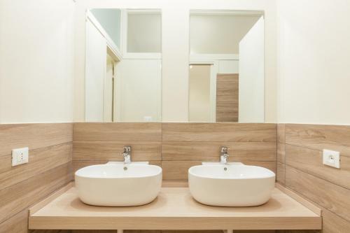 a bathroom with a white sink and a mirror at Tomato Backpackers in Turin