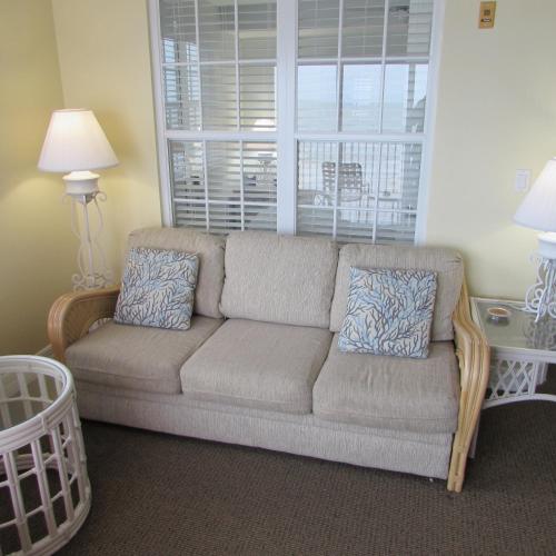 a living room with a couch and a window at Edison Beach House in Fort Myers Beach