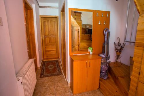 a hallway with a wooden cabinet and a door at Apartmani Mila in Žabljak