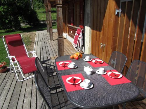 a table on a deck with a plate of food at Lodge 24 in Illiswil
