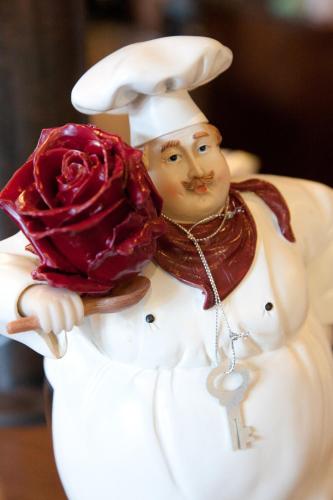 a figurine of a chef holding a rose at Hotel Restaurant Friedrichs in Nebel