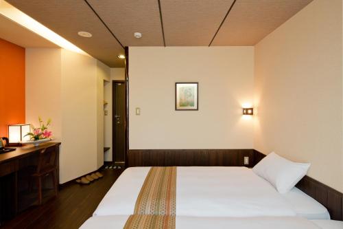Säng eller sängar i ett rum på The Edo Sakura