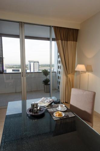 a living room with a table with food on it at The Apartments, Dubai World Trade Centre in Dubai
