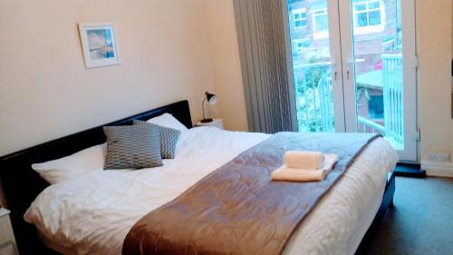 a bedroom with a bed with a towel on it at Marine Lake apartment in West Kirby
