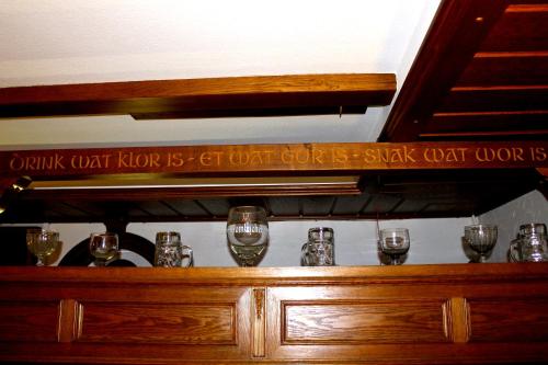a wooden shelf with wine glasses on it at Hotel Fährhaus Ziehl in Geesthacht